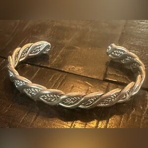 Silver cuff bracelet with sort of feather weave throughout